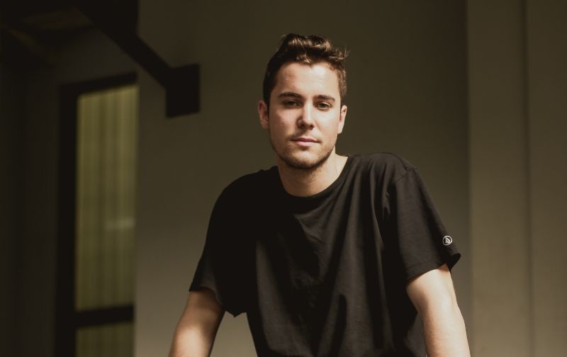 A young man sitting on a wall 