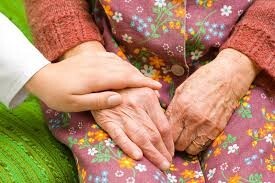 A hand comforting an older lady