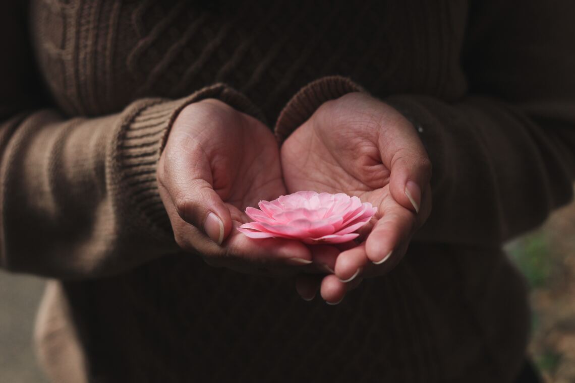 Photo of woman holding flower