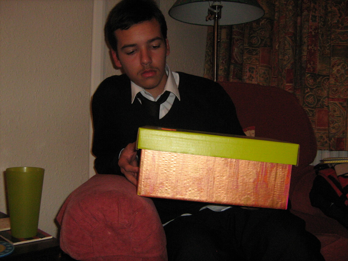 Photo of young person with box of resources