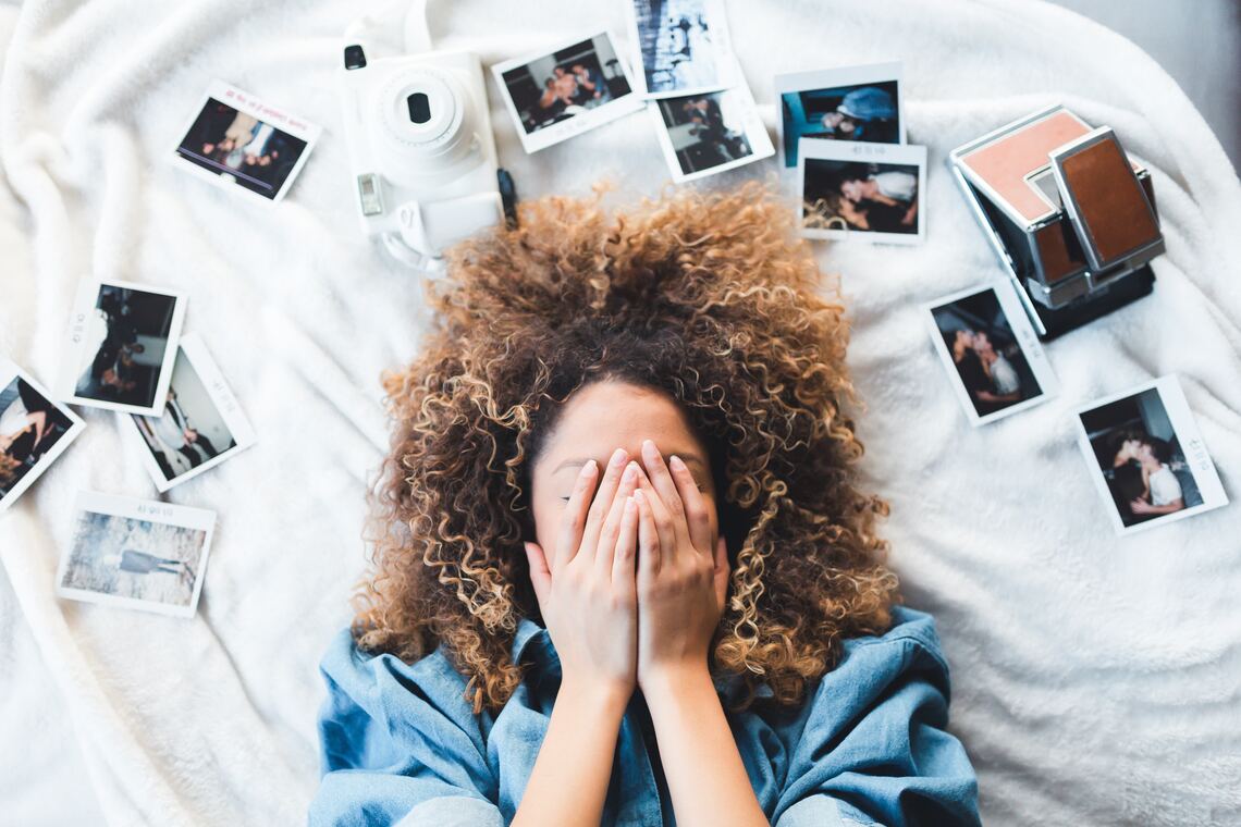 A young woman surrounded by photographs
